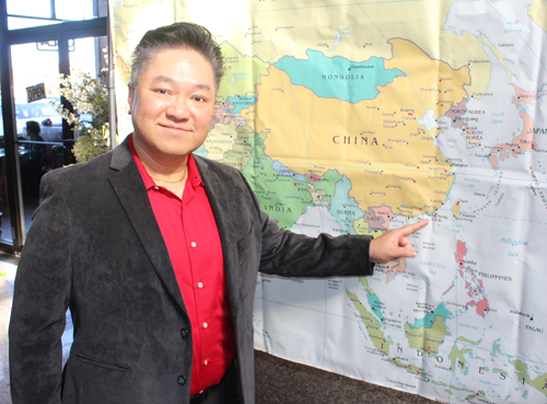 Wayne Wong points to the map of China