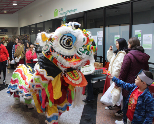 Kwan Family Lion Dance team coming through Asia Plaza