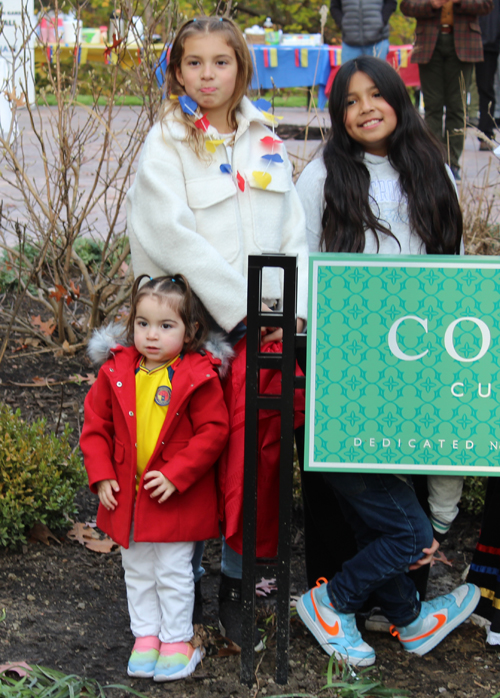 Kids at Colombia Garden sign