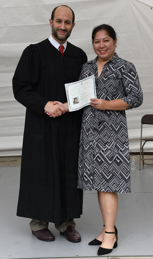 New citizens with Judge at Naturalization Ceremony at One World Day