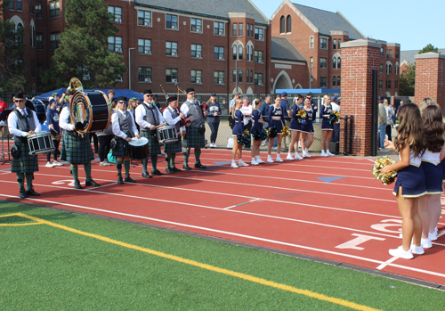 Irish American Club East Side Pipe and Drums piping in the football team