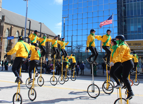 St Helens unicycles at 2025 Cleveland St Patrick's Day Parade