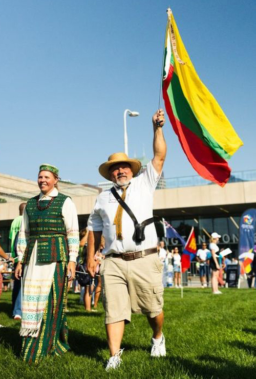 Veronica & Peter Taraska carrying the flag of Lithuania at the welcoming celebration